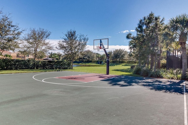 view of sport court featuring community basketball court, a lawn, and fence