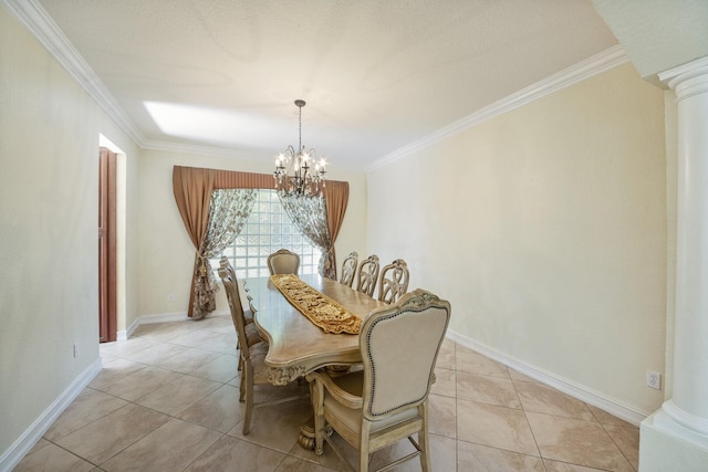 dining area featuring a notable chandelier, crown molding, baseboards, and decorative columns