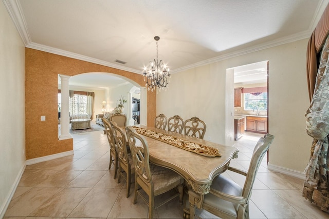 dining area featuring an inviting chandelier, light tile patterned floors, visible vents, and arched walkways