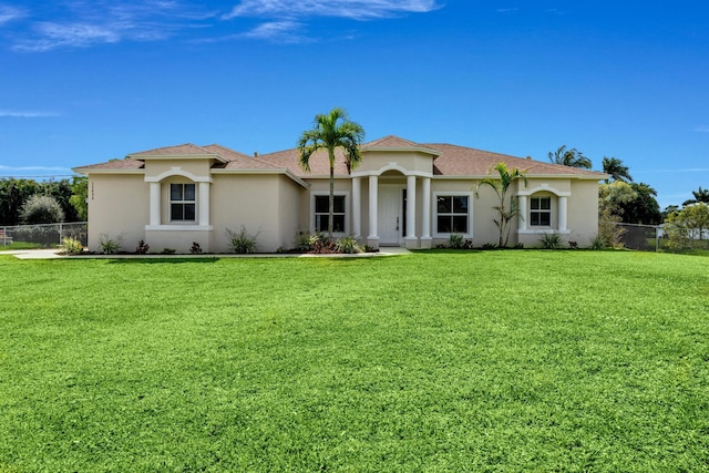 mediterranean / spanish-style home with a front lawn