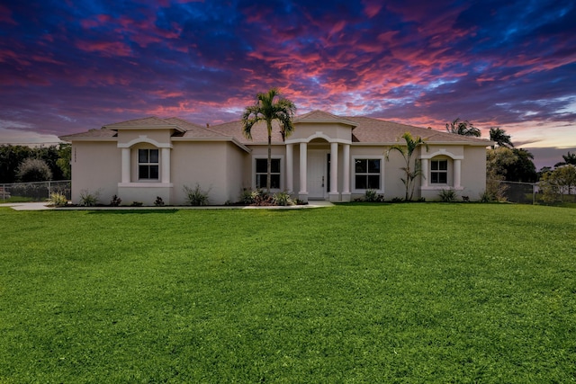 mediterranean / spanish-style house with a yard