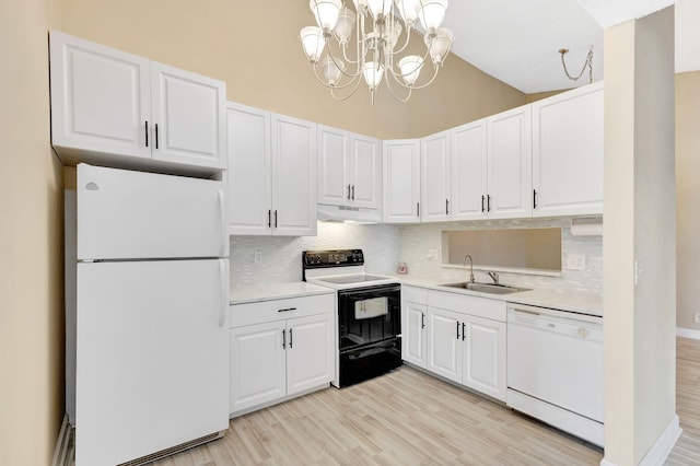 kitchen featuring white appliances, light countertops, and white cabinets