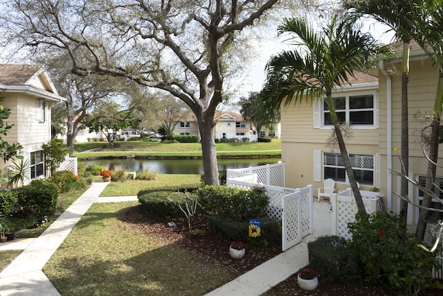 view of yard featuring a water view and fence