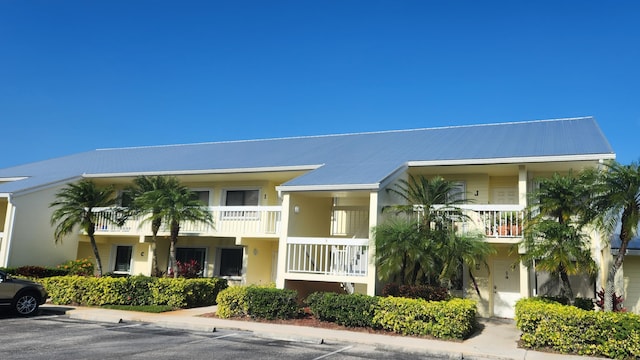 4300 Gator Trace Dr Unit D, Fort Pierce, FL 34982 - townhome / multi-family property featuring a balcony, stucco siding, metal roof, and uncovered parking