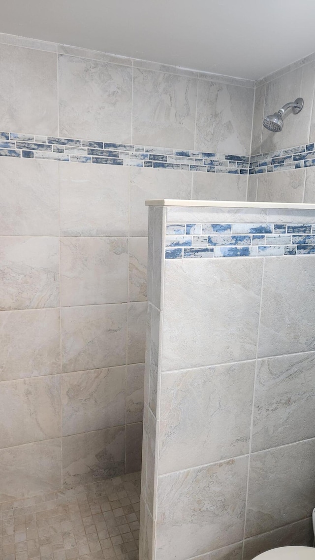 bathroom with a tile shower