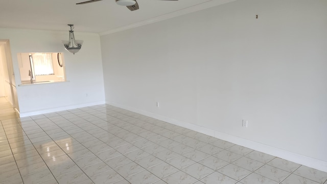 empty room featuring ornamental molding and ceiling fan