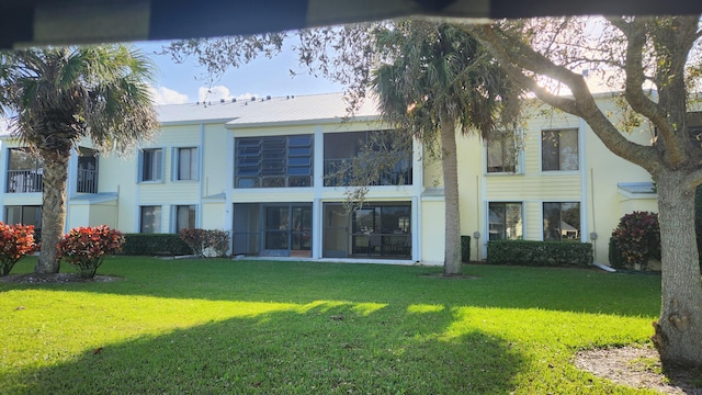 rear view of property featuring a yard