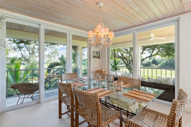 sunroom / solarium featuring an inviting chandelier and wood ceiling