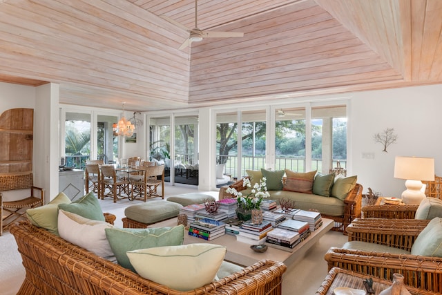 sunroom featuring ceiling fan with notable chandelier and wooden ceiling