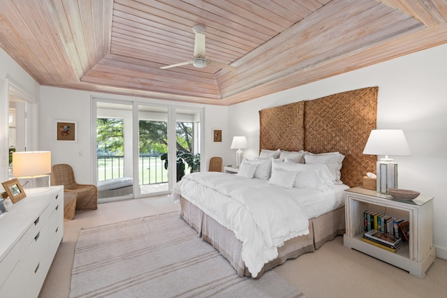 bedroom with light carpet, wood ceiling, access to outside, and a tray ceiling