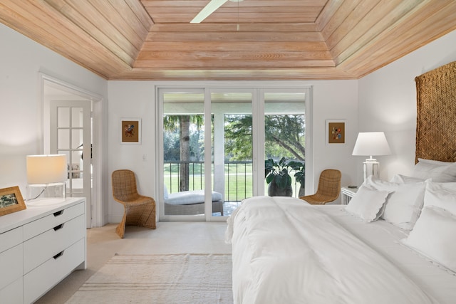 bedroom with a raised ceiling, crown molding, wooden ceiling, and access to exterior