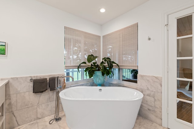 bathroom with tile walls and a washtub