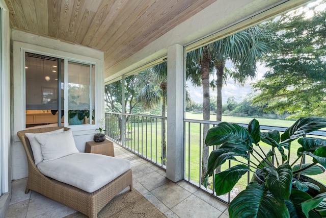 sunroom featuring wood ceiling