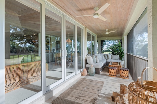 sunroom with wooden ceiling and ceiling fan