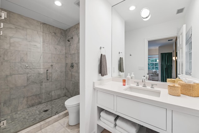 bathroom with tile patterned flooring, vanity, an enclosed shower, and toilet