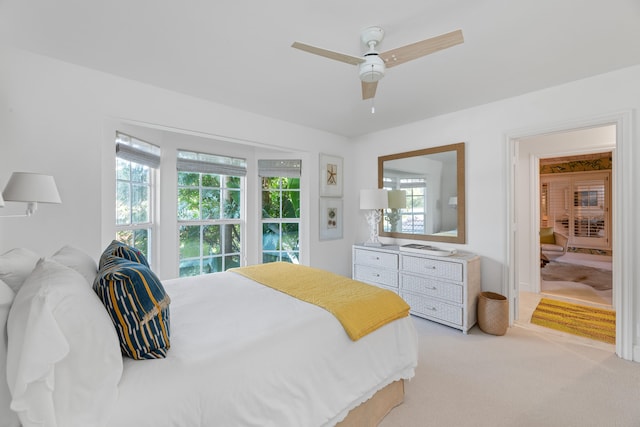 bedroom with light carpet and ceiling fan