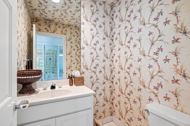 bathroom featuring vanity and toilet