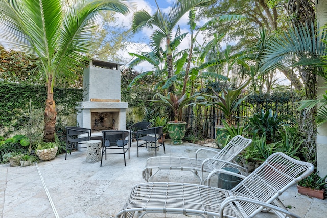 view of patio with an outdoor fireplace