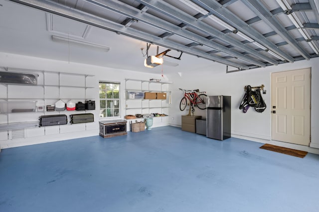 garage featuring a garage door opener and stainless steel refrigerator