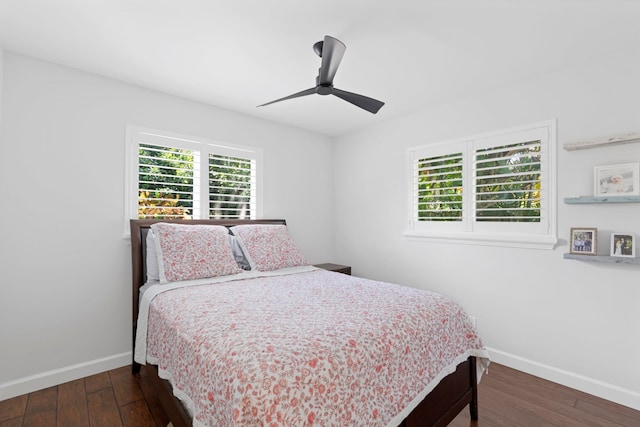 bedroom featuring a ceiling fan, dark wood-style flooring, and baseboards