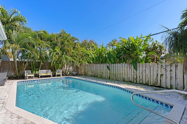 view of swimming pool featuring a fenced in pool and a fenced backyard