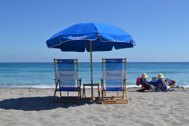 view of property's community with a water view and a beach view