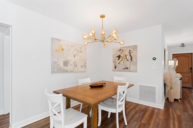 dining room featuring dark wood-style floors, a chandelier, visible vents, and baseboards