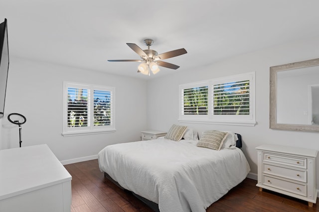 bedroom featuring ceiling fan, dark wood finished floors, and baseboards