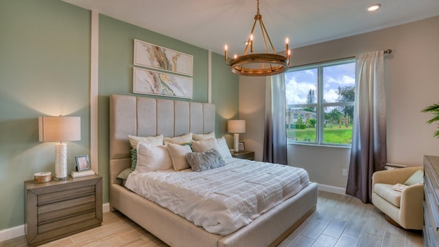 bedroom featuring light wood-type flooring, recessed lighting, baseboards, and an inviting chandelier