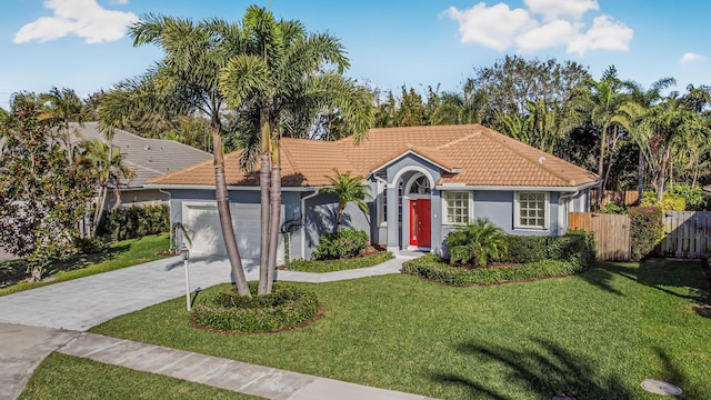 view of front of house featuring an attached garage, a tile roof, fence, concrete driveway, and a front yard