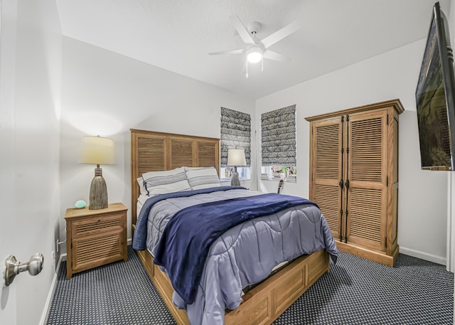 carpeted bedroom featuring a ceiling fan and baseboards