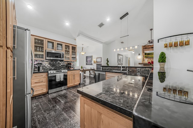 kitchen featuring stainless steel appliances, dark wood-style flooring, a sink, visible vents, and tasteful backsplash