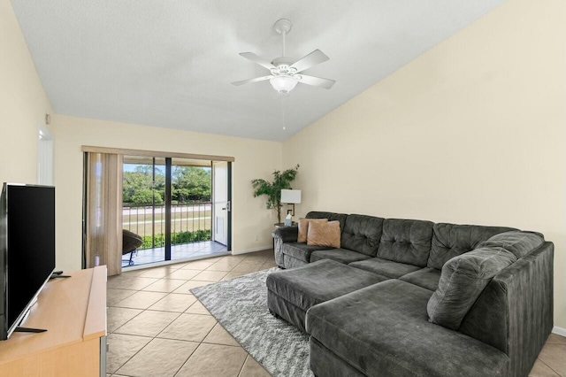 living area with lofted ceiling, light tile patterned flooring, a ceiling fan, and baseboards