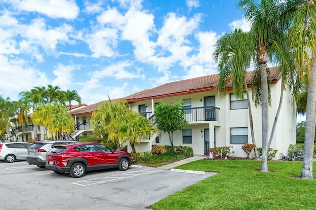 view of building exterior with uncovered parking