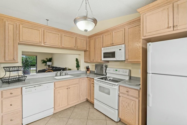 kitchen featuring light brown cabinetry, white appliances, light tile patterned flooring, and a sink