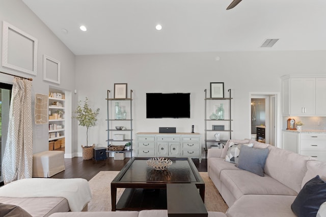 living room with dark wood-type flooring and ceiling fan