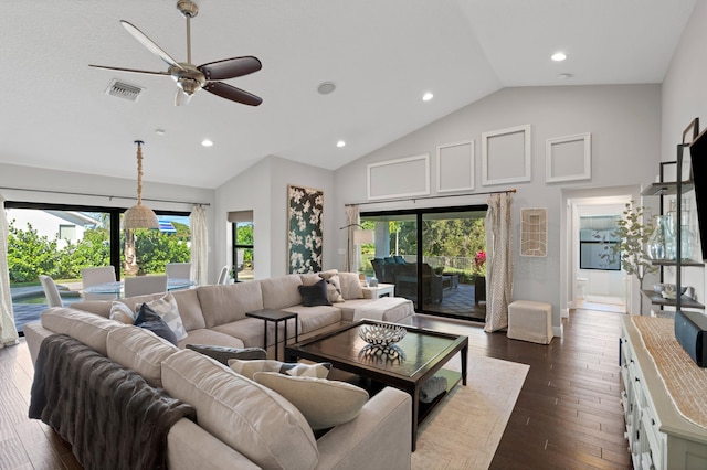 living room with plenty of natural light, high vaulted ceiling, dark hardwood / wood-style floors, and ceiling fan