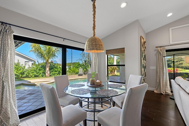 dining area with lofted ceiling and hardwood / wood-style floors