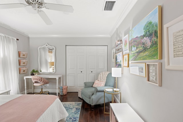 bedroom with crown molding, ceiling fan, dark hardwood / wood-style flooring, and a closet