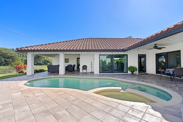 view of pool with an outdoor living space, a patio area, ceiling fan, and an in ground hot tub