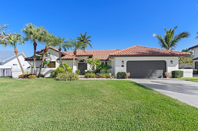 mediterranean / spanish house featuring a garage and a front yard