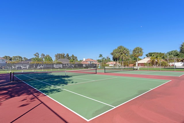 view of tennis court featuring basketball hoop