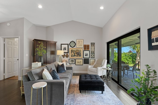 living room with high vaulted ceiling and dark hardwood / wood-style flooring