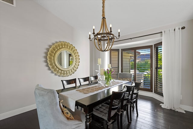 dining area with vaulted ceiling, dark hardwood / wood-style floors, and a chandelier