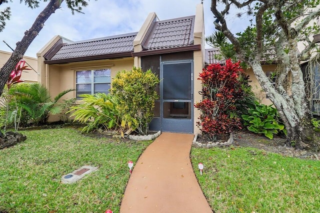 entrance to property with a yard