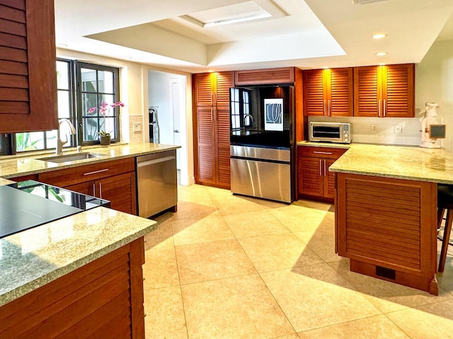 11373 Twelve Oaks Way E, North Palm Beach, FL 33408 - kitchen featuring smart refrigerator, a raised ceiling, stainless steel dishwasher, light stone counters, and recessed lighting