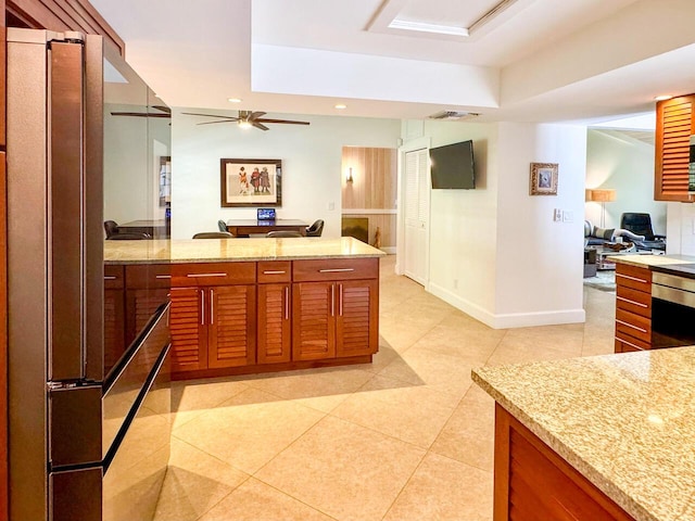11373 Twelve Oaks Way E, North Palm Beach, FL 33408 - kitchen with high quality fridge, a ceiling fan, light tile patterned floors, light stone counters, and recessed lighting