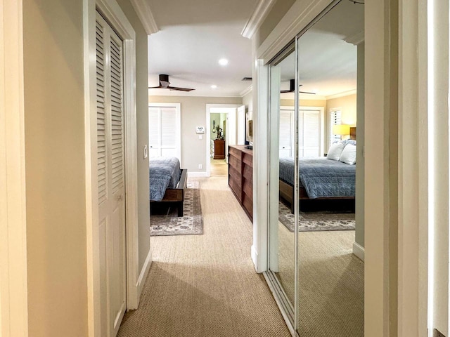 11373 Twelve Oaks Way E, North Palm Beach, FL 33408 - hall with ornamental molding, light colored carpet, baseboards, recessed lighting, and healthy amount of natural light