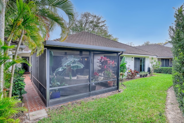 11373 Twelve Oaks Way E, North Palm Beach, FL 33408 - back of house with a sunroom, a yard, and stucco siding