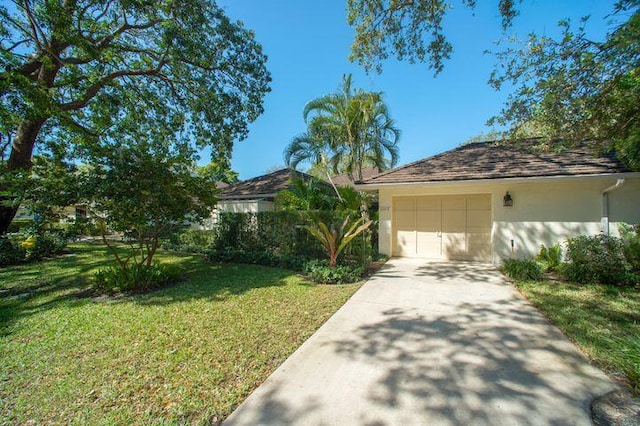 11373 Twelve Oaks Way E, North Palm Beach, FL 33408 - view of front of property with driveway, a front lawn, and stucco siding